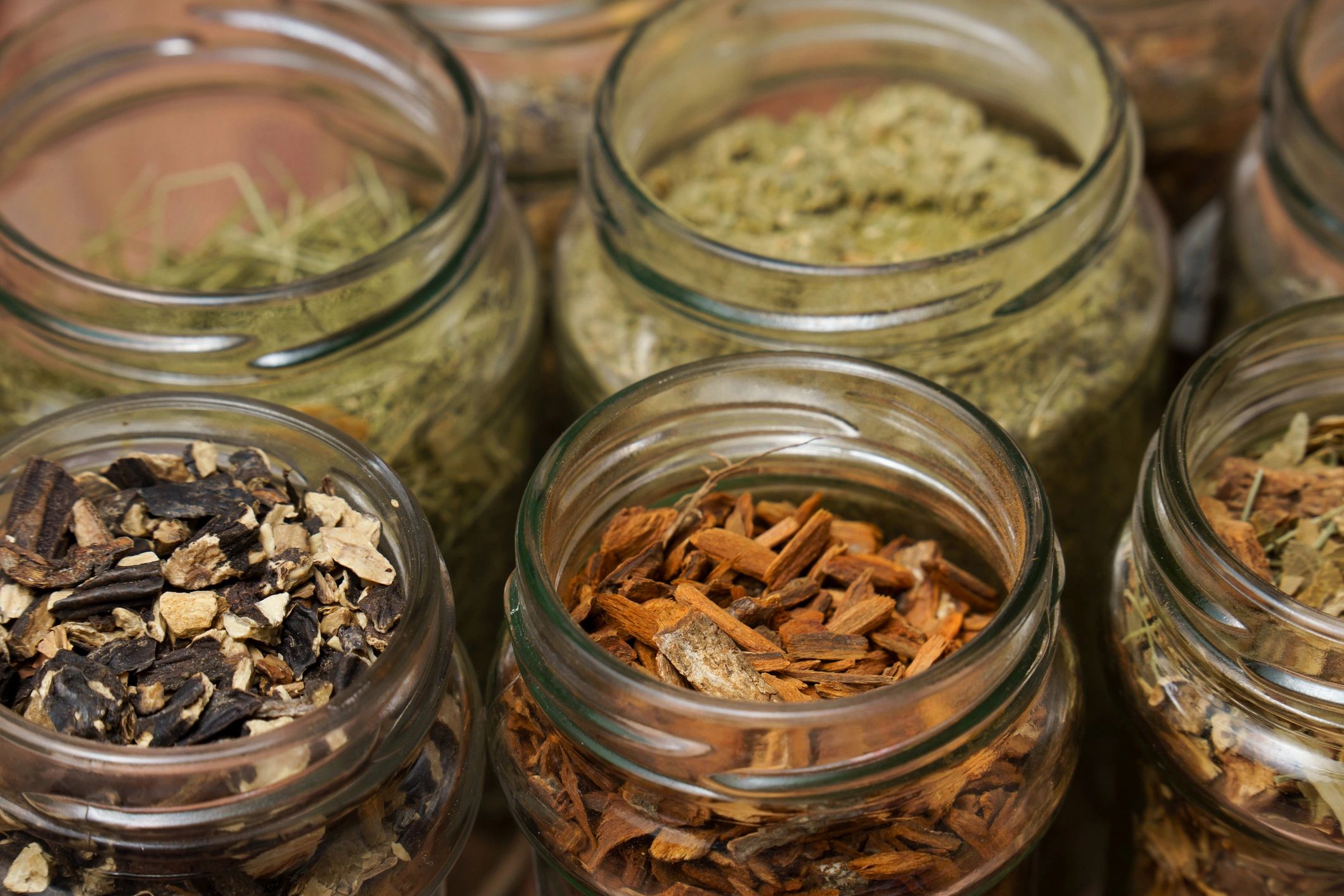 Glass jars filled with dried herbs and cooking ingredients